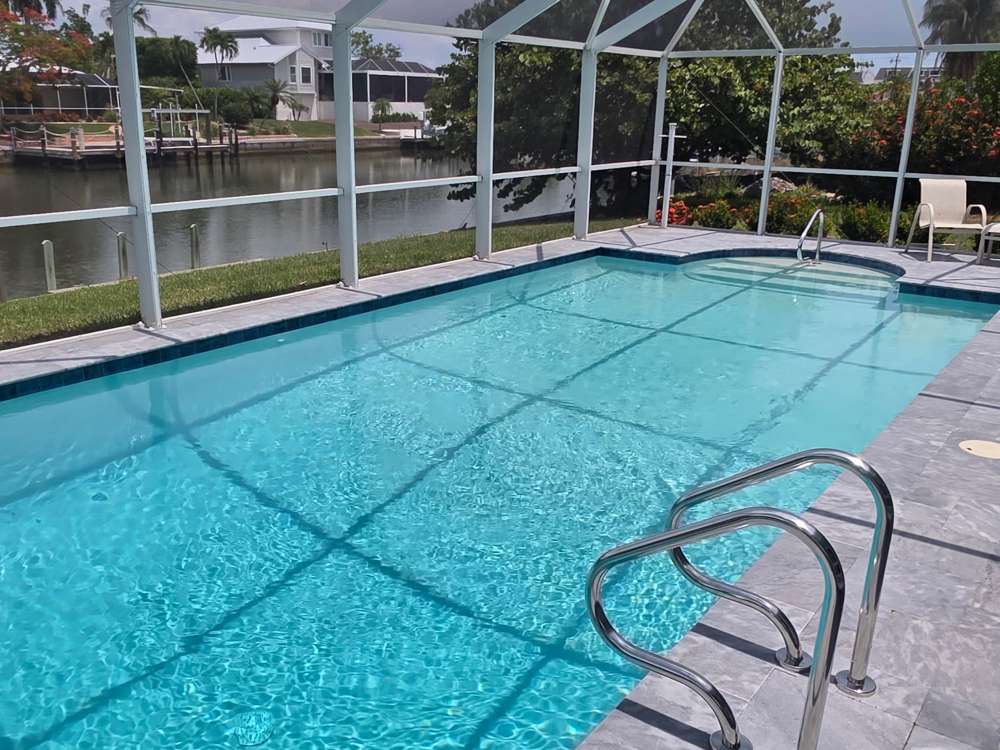 Screened lanai pool with a lake view