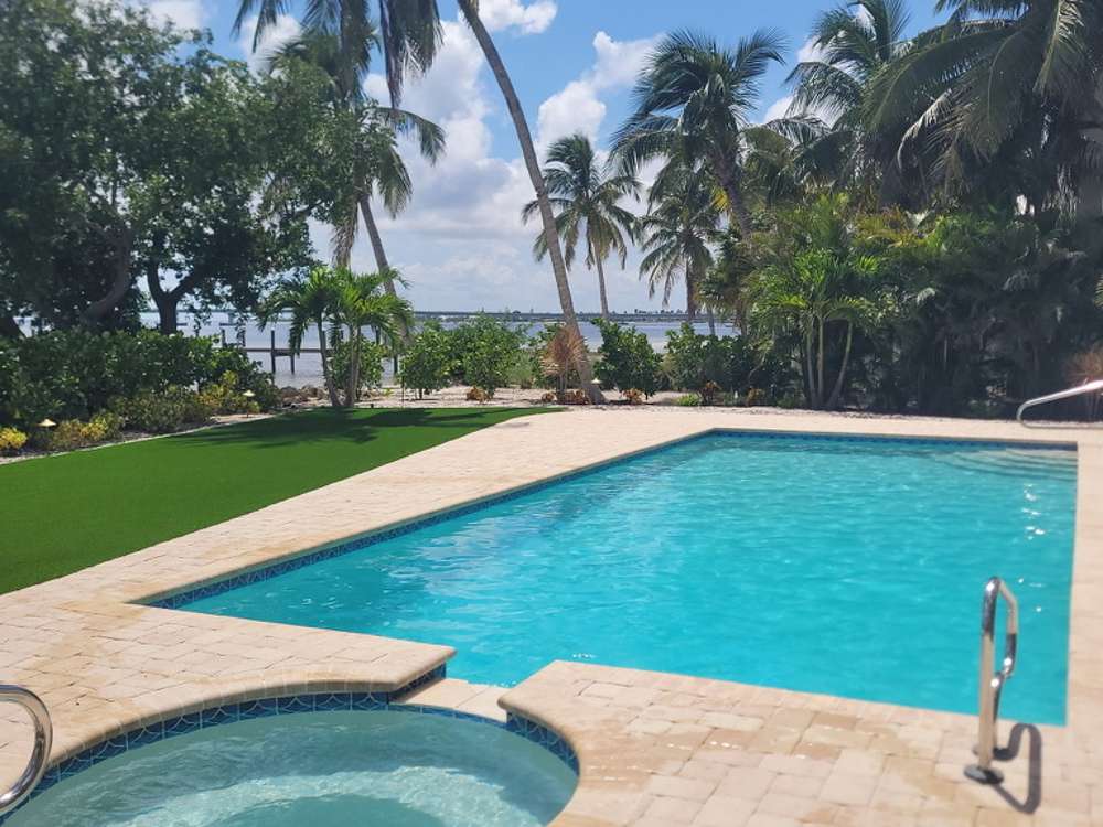 Keys-style pool and spa overlooking the bay with palms